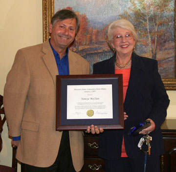 nancye mcclure retirement web DR. NANCYE MCCLURE, professor of English at Missouri State University-West Plains, was recognized for her 11 1/2 years of service to the university during a recent retirement reception at Kellett Hall. McClure joined the university as an instructor on Aug. 13, 2001, and was promoted to assistant professor on Aug. 12, 2002. On Aug. 14, 2006, she was promoted to associate professor and granted tenure, and on Aug. 15, 2011, she was promoted to professor. Her official retirement date will be Feb. 1, 2013. Above, she receives a framed certificate from Chancellor Drew Bennett. (Missouri State-West Plains Photo)