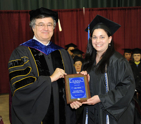 ASHLEY ROBISON, West Plains, received the Outstanding Student Award for Associate of Science in Nursing degree graduates at Missouri State University-West Plains’ commencement ceremonies Saturday, May 18, at the West Plains Civic Center.  The award recognizes a graduate from ASN program who exhibits academic achievement and honesty, class participation, conscientiousness, university and community service, and outstanding clinical performance.  Robison graduated with both the ASN and Associate of Arts in General Studies degrees at Saturday’s commencement.  She received her award from Dean of Academic Affairs Dr. Christopher Dyer.  (Missouri State-West Plains Photo)ASHLEY ROBISON, West Plains, received the Outstanding Student Award for Associate of Science in Nursing degree graduates at Missouri State University-West Plains’ commencement ceremonies Saturday, May 18, at the West Plains Civic Center.  The award recognizes a graduate from ASN program who exhibits academic achievement and honesty, class participation, conscientiousness, university and community service, and outstanding clinical performance.  Robison graduated with both the ASN and Associate of Arts in General Studies degrees at Saturday’s commencement.  She received her award from Dean of Academic Affairs Dr. Christopher Dyer.  (Missouri State-West Plains Photo)