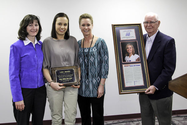 FORMER GRIZZLY Volleyball standout Luiza Jarocka, second from left, was inducted into the Grizzly Hall of Fame by Missouri State University-West Plains and Grizzly Booster Club officials during the annual Grizzly Sports Banquet/Hall of Fame Induction Ceremony Tuesday evening, April 8, at the West Plains Civic Center’s Magnolia Room.  She received her award from former Grizzly Volleyball Head Coach Trish Knight, left; current Head Coach Paula Wiedemann, third from left; and Grizzly Hall of Fame Selection Committee Chairman Ron Shemwell.  (Missouri State-West Plains Photo)