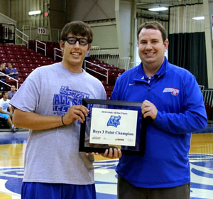 SETH HENSLEY, left, Hartville, won the boys 3-point shooting competition at the annual Grizzly All-Star Classic Saturday, April 19, at the West Plains Civic Center.  He receives his award from Missouri State University-West Plains Head Coach Yancey Walker.  (Photo provided)