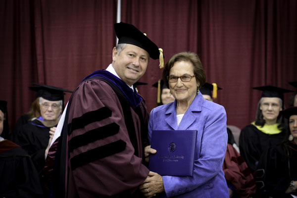 WEST PLAINS RESIDENT PEGGY KISSINGER received an honorary Associate of Arts degree Saturday, May 17, during Missouri State University-West Plains’ commencement ceremony at the West Plains Civic Center arena.  She received her degree from Missouri State-West Plains Chancellor Drew Bennett.  (Missouri State-West Plains)