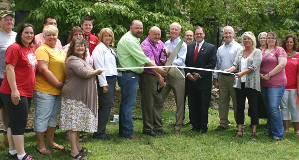 SOUTH CENTRAL Education Consortium Director Scott Williamson cuts the ribbon on the Willow Springs facility where Three Rivers College and Missouri State University – West Plains offer college courses and career technical programs. To Williamson’s right are state Rep. Shawn Rhoads and Willow Springs Chief Financial Officer Beverly Hicks. To his left are state Sen. Mike Cunningham, Three Rivers Interim President Dr. Wesley Payne, and Missouri State-West Plains Interim Dean of Academic Affairs Dennis Lancaster.