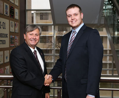 JARED CATES, right, West Plains, a May 2010 graduate of Missouri State University-West Plains and a graduate student at Missouri State-Springfield, was one of six students who received the 2014-15 Citizen Scholar Award presented today, Dec. 12, by the Missouri State University Board of Governors.  The award, established in fall 2007, is given annually to students “who exemplify the concept of a citizen scholar,” university officials said.  Congratulating Cates above is Missouri State-West Plains Chancellor Drew Bennett.  (Missouri State-West Plains Photo)