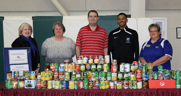 A TOTAL OF 219 canned and non-perishable food items have been collected for the local Bridges program by members of the Grizzly Basketball team as part of its food drive this season, which is being conducted in partnership with the Enactus student organization at Missouri State University-West Plains.  With the collected items above are, from left, Enactus Co-Faculty Adviser Cathy Proffitt-Boys, Bridges Coordinator Cyndi Wright, freshman Grizzly guard Dazhonetae Bennett, Grizzly Basketball Head Coach Yancey Walker and Enactus Co-Faculty Adviser Renee Moore.  (Missouri State-West Plains Photo).