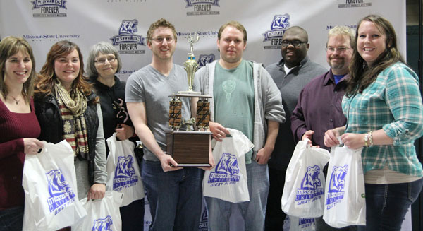  THE TEAM from the Missouri Public Defenders Office in West Plains took home top honors in the 12th annual Trivia Night to benefit Grizzly Athletics at Missouri State University-West Plains.  With the traveling trophy are team members, from left, Jodi Hoopes, Bethany Hanson, Donna Anthony, Bryce Crowley, Roger Dyer, Maurice Brewer, David Dykas and Sarah Bernard.  (Missouri State-West Plains Photo)