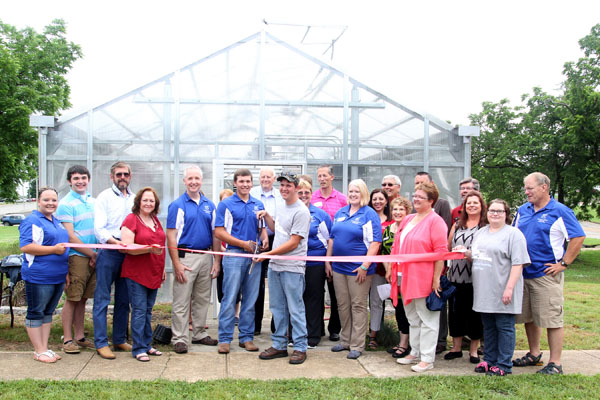 THE GRIZZLY GREENHOUSE on the Missouri State University-West Plains campus officially opened for business Tuesday morning with a ribbon cutting ceremony and open house hosted by university officials and the West Plains Area Chamber of Commerce.  Over 50 students, faculty, staff and area residents attended the event.  The greenhouse, which cost an estimated $110,000 to construct, will provide a teaching laboratory for students enrolled in the university’s agribusiness educational programs developed as part of the $2.5 million U.S. Department of Labor’s Trade Adjustment Assistance Community College and Career Training (TAACCCT) Grant Program at the university, officials said.  The facility is designed to teach a variety of horticultural techniques, including conventional horticulture, companion plantings, raised beds and aquaculture.  With the ribbon are, front row from left, agriculture student Hailey Bunch, West Plains; Student Government Association President Casey Buehler, West Plains; Norm Haining and Carolyn Henry, both of Poplar Bluff, who donated fish tanks for the aquaculture program; Dean of Academic Affairs Dr. Dennis Lancaster; agriculture students Kaleb Stolba, Willow Springs, and Cheston Malam, Houston; Assistant Professor of Agriculture Dr. Linda Wulff-Risner; Assistant Professor of Agriculture/Entrepreneurship Cathy Proffitt-Boys; TAACCCT Project Manager Sheila Barton; agriculture student Elizabeth Church, Alton; and greenhouse manager Craig Jennings.  (Missouri State-West Plains photo)