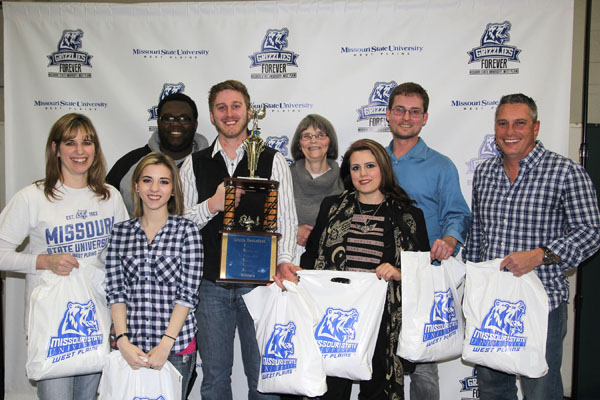 THE TEAM from the Missouri Public Defenders Office in West Plains took home top honors in the 13th annual Trivia Night to benefit Grizzly Athletics at Missouri State University-West Plains. With the traveling trophy are team members, from left, Jodi Hoopes, Katey Hoopes, Maurice Brewer, Bryce Crowley, Donna Anthony, Cansas Bell, Jeff Waltemate and Tom Sheridan.  (Missouri State-West Plains Photo)