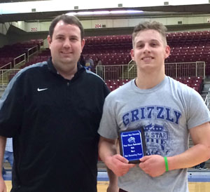 CHRISTIAN BROWN, Logan-Rogersville, was named the most valuable player in the boys game of the annual Grizzly All-Star Classic Saturday, March 26, at the West Plains Civic Center arena.  He scored 27 points to help lead his team to a 96-91 win.  Duncan receives his award from Missouri State University-West Plains Grizzly Basketball Head Coach Yancey Walker.  (Photo provided)
