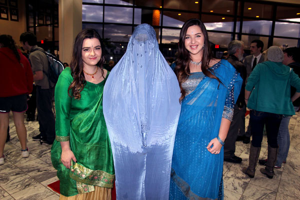 A FASHION SHOW featuring traditional attire from Central Asia and the Middle East modeled by Missouri State University-West Plains students was one of the highlights of the “Journey Through Central Asia and the Mideast” reception Feb. 25 at the West Plains Civic Center. The event, hosted by the college’s University/Community Programs (U/CP) Department, capped the department’s month-long February Film Series, which featured movies about these regions. In addition to the fashion show, the 174 community members, faculty, staff and students who attended also enjoyed tasty cuisine common in those areas of the world. Above, from left, are Kelsey Farris, West Plains, in a silk Sharara from India; Katie Henson, Stoutland, in a periwinkle burqa from Afghanistan, and Morgan Kinder, West Plains, in a turquoise three-piece saree from India. Items used in the fashion show were on loan from area residents who have lived or worked in these regions, organizers said. (Missouri State-West Plains Photo)