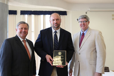 DR. PHILLIP HOWERTON, center, associate professor of English at Missouri State University-West Plains, received the Governor’s Award for Excellence in Education during an April 13 luncheon in Jefferson City, Mo. With him are Missouri State-West Plains Chancellor Drew Bennett, left, and Missouri Associate Commissioner of Higher Education Rusty Monhollon. (Photo provided)