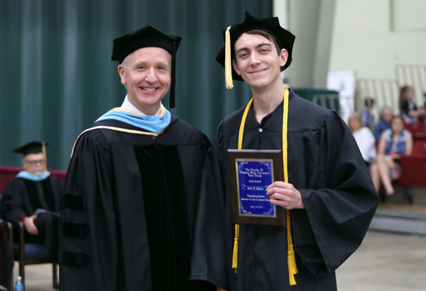 SETH HADLEY, right, Birch Tree, received the Outstanding Student Award for Associate of Arts/Associate of Science/Associate of Applied Science degree graduates at Missouri State University-West Plains’ commencement ceremonies Saturday, May 14, at the West Plains Civic Center. The award recognizes a graduate from either the AA, AS or AAS programs who exhibits academic excellence, interest and enthusiasm in learning, conscientiousness, academic honesty, a willingness to participate and help others in class, and exceptional university and community service. Hadley graduated with an Associate of Arts in General Studies degree. Presenting Hadley his award above is Dean of Academic Affairs Dr. Dennis Lancaster.  (Missouri State-West Plains Photo)