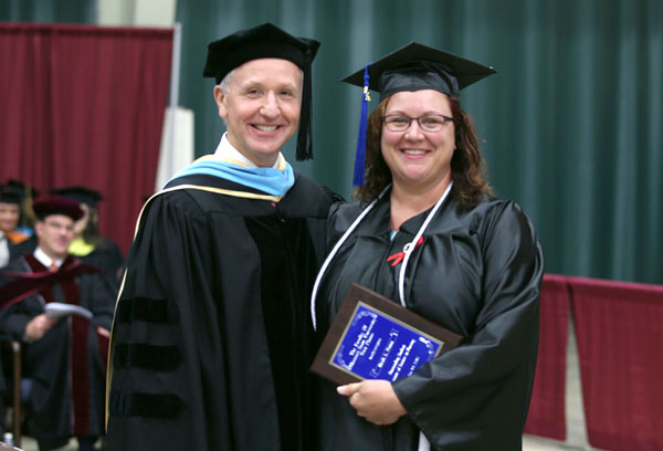 HEIDI PETTIT, West Plains, received the Outstanding Student Award for Associate of Science in Nursing degree graduates at Missouri State University-West Plains’ commencement ceremonies Saturday, May 14, at the West Plains Civic Center. The award recognizes a graduate from ASN program who exhibits academic achievement and honesty, class participation, conscientiousness, university and community service, and outstanding clinical performance. Above, Pettit receives her award from Dean of Academic Affairs Dr. Dennis Lancaster.  (Missouri State-West Plains Photo)