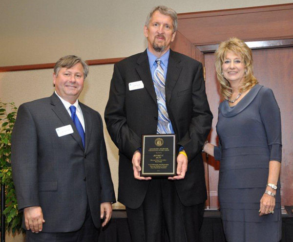 JEFFREY C. HUFF, center, associate professor of computer graphics and programming at Missouri State University-West Plains, received the Governor’s Award for Excellence in Education during an April 4 luncheon in Columbia, Mo. With him are Missouri State-West Plains Chancellor Drew Bennett, left, and Kathryn Swan, Cape Girardeau, chairwoman of the Missouri Coordinating Board for Higher Education (CBHE). (Photo provided)