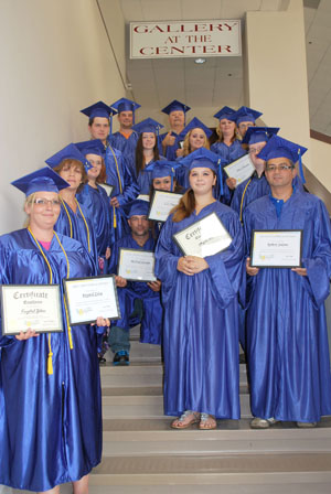 SOME OF THE STUDENTS graduating from the Adult Education and Literacy (AEL) high school equivalency program show their diplomas following graduation ceremonies July 20. (Photo provided)