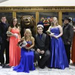 MEMBERS OF THE 2014 Missouri State University-West Plains Homecoming Court gather around this year’s king and queen in the lobby of the West Plains Civic Center for photos following the crowning, which took place at halftime of the Jan. 18 basketball game between the Grizzlies and Three Rivers College Raiders of Poplar Bluff, Mo. Seated are 2014 Grizzly Homecoming Queen Brady Peterson, West Plains, and King Zach Collins, Willow Springs. Standing from left are 2014 Homecoming King and Queen candidates T. J. Wallis, New Bloomfield; Anyta Cavitt, West Plains; John Beam, West Plains; and Sarah Agee, Conway; Grizz (Sam Dodson, West Plains); Ms. Grizz (Allison Sweatt, Camdenton); and candidates Ashley Howell, West Plains; Bruce Cavitt, West Plains; Amanda Justus, Vienna; and Aaron Orchard, Rogersville. (Missouri State-West Plains Photo).