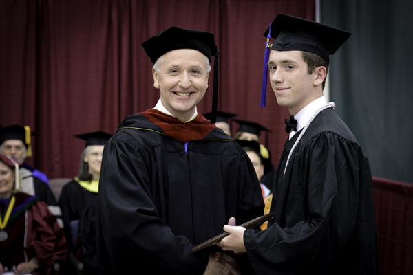 NICHOLAS SMITH, right, West Plains, received the Outstanding Student Award for Associate of Arts/Associate of Science in Business/Associate of Applied Science degree graduates at Missouri State University-West Plains’ commencement ceremonies Saturday, May 17, at the West Plains Civic Center. The award recognizes a graduate from either the AA, ASB or AAS programs who exhibits academic excellence, interest and enthusiasm in learning, conscientiousness, academic honesty, a willingness to participate and help others in class, and exceptional university and community service. Smith graduated with an Associate of Arts in General Studies degree. He received his award from Interim Dean of Academic Affairs Dennis Lancaster. (Missouri State-West Plains Photo)
