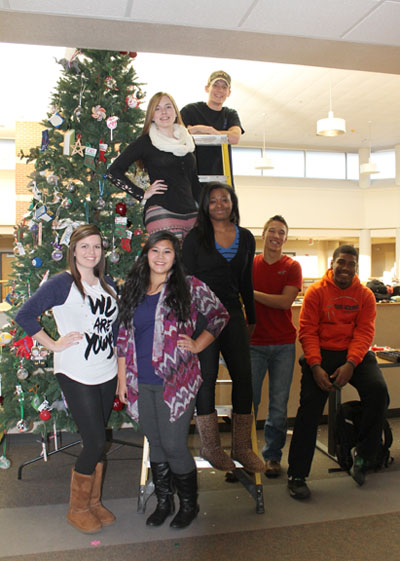 STUDENTS from the Future Alumni Organization with the tree for the 9th annual tree lighting ceremony include front row from left, Allison Sweatt, Camdenton; Jahmia Jujan, Dixon; Danisha Hogue, St. Louis; Zach Kaufman, West Plains; and Young. Back row: Reagan Caldwell, Plato; and TJ Wallis, New Bloomfield. (Missouri State-West Plains photo)