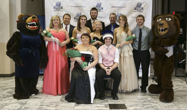 MEMBERS OF THE 2015 Missouri State University-West Plains Homecoming Court gather around this year’s king and queen in the lobby of the West Plains Civic Center for photos following the crowning, which took place at halftime of the Jan. 17 basketball game between the Grizzlies and Three Rivers College Raiders of Poplar Bluff, Mo. Seated are 2015 Grizzly Homecoming Queen Emily Yeager, Dora, and King Lance Parker, Dixon. Standing from left are Ms. Grizz (Ashton Garner, West Plains); 2015 Homecoming King and Queen candidates Ashley Howell, West Plains; Shannon Ford, Mtn. View; Kimberly Allen, Summersville; Cody Tompkins, West Plains; Kendra Barnard, St. Charles; Regan Riggs, West Plains; Ashley Rieken, Ava; and Trevor Cressman, West Plains; and Grizz (Sam Dodson, West Plains). (Missouri State-West Plains Photo)
