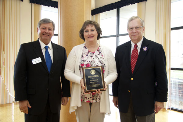 JUDY CARR, center, associate professor of psychology/sociology at Missouri State University-West Plains, received the Governor’s Award for Excellence in Education during an April 7 luncheon in Jefferson City, Mo. With her are Missouri State-West Plains Chancellor Drew Bennett, left, and Missouri Commissioner of Higher Education David R. Russell. (Photo provided)