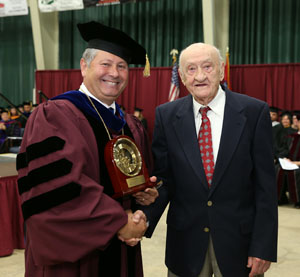 LONG-TIME WEST PLAINS BUSINESSMAN and community leader Norman “Joe” Spears, right, received the prestigious Granvil Vaughan Founder’s Award during Saturday’s Missouri State-West Plains commencement ceremonies at the West Plains Civic Center. Above, Spears receives the award from Missouri State-West Plains Chancellor Drew Bennett. (Missouri State-West Plains Photo)