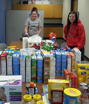 STUDENTS IN FAMILY HEALTH classes at Missouri State University-West Plains last fall used couponing strategies to purchase these items for three area agencies that provide services to individuals and families in need. With the items are Taya White, left, of Salem, Missouri, and Alex Harris, West Plains. (Photo provided)