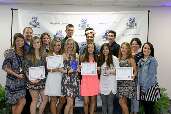 SEVERAL MEMBERS of the 2015-2016 Grizzly Cheer Team at Missouri State University-West Plains received individual awards at the annual Grizzly Sports Reception/Hall of Fame Induction Ceremony Friday evening, April 22, at the West Plains Civic Center’s Magnolia Room. Front row from left, Katelyn Grogan, Cabool, Outstanding Leadership-Female; Micaela Wiehe, West Plains, Crowd Favorite-Female; Bobbi Taylor, Gainesville, Most Spirit; Mackenzie Lamb, Imperial, Best Overall; Jessie Dowler, Birch Tree, Best Flyer; Brittany Farias, Mountain View, Coaches’ Award for Excellence; Miranda Donnelly, Waynesville, Most Improved; Assistant Cheer Team Coach Keena Simpson. Back row: Head Coach Nick Pruitt; Lance Parker, Dixon, Outstanding Leadership-Male; Colt Tompkins, West Plains, Best Base; Amber Robinson, Hazelwood, Manager; Mike Driscoll, Koshkonong, Crowd Favorite-Male; Cheer Team Coordinator Rachel Peterson. (Missouri State-West Plains Photo)