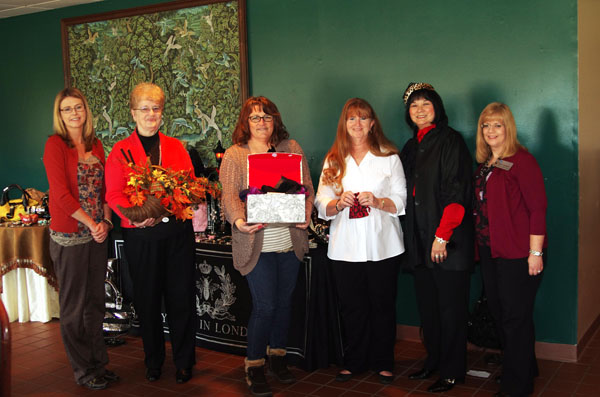 THREE WOMEN from West Plains were winners of giveaways at the “Red Carpet Event” fashion show and luncheon Friday, Nov. 9, presented by The Kloz Klozet and Cottage Flowers & Interiors to benefit the Garnett Library at Missouri State University-West Plains. From left are Kristi Dake, owner of Cottage Flowers & Interiors; Anita Stevens, winner of the Cottage Flowers & Interiors giveaway; Teri Townsend, winner of the giveaway offered by both Cottage Flowers and The Kloz Klozet; Sandra Reed, winner of The Kloz Klozet giveaway; Florence James, owner of The Kloz Klozet; and Garnett Library Director of Library Services Sylvia Kuhlmeier. The event was sponsored by Friends of the Garnett Library. (Missouri State/West Plains Photo)
