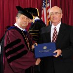 FORMER BANK EXECUTIVE Paul Childers, right, received an honorary Associate of Applied Science degree Saturday, May 19, during Missouri State University-West Plains’ commencement ceremony at the West Plains Civic Center arena. He received his degree from Missouri State-West Plains Chancellor Drew Bennett. (Missouri State-West Plains)
