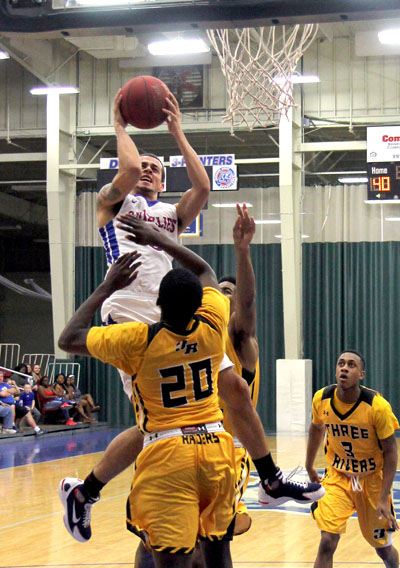 GRIZZLY POINT GUARD RICKY TORRES goes up in traffic as he drives to the basket during Saturday’s annual homecoming game against Three Rivers College. Torres led the team in scoring with 16 points. (Missouri State-West Plains Photo)