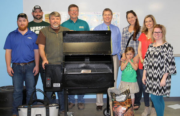 GET READY FOR SUMMER with this Smokin’ Brothers Grill, hickory pellets and a Yeti cooler from Hirsch Feed and Farm Supply. These items are among many that will be sold during Missouri State University-West Plains’ “True Blue” Annual Auction, set for April 10 at the West Plains Civic Center. Hirsch officials valued the grill and pellets at $960.99 and the cooler at $277.49. Doors will open at 5:30 p.m., and auction activities will get underway at 6. Tickets are $35 per person, or $350 will reserve table seating and tickets for eight, organizers said. Tickets can be purchased by calling 417-255-7240 or emailing WPDevelopment@MissouriState.edu. With “True Blue” as this year’s theme, guests are being asked to wear blue. From left above are Hirsch Animal Health and Feed Specialist Jordan Kinder, Equipment Sales Ryan Johnson, Store Manager John Williams and Parts Manager Greg Brown; Missouri State-West Plains Director of Development Joe Kammerer; auction committee member Quanna Hafer and daughter, Violet; acution committee member Amy Thomas; and Assistant Director of Development Melody Hubbell. (Missouri State-West Plains Photo)