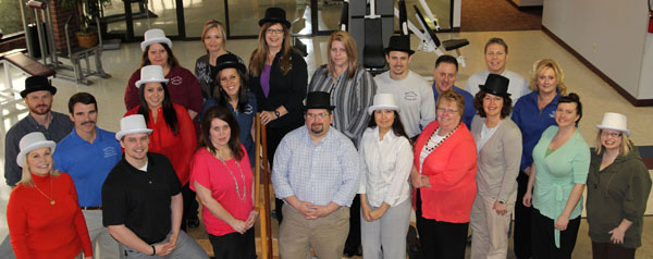 OFFICIALS AT MISSOURI State University-West Plains are tipping their hats to Physical Therapy Specialists Clinic (PTSC) for being a bronze level sponsor of the annual auction April 11 at the West Plains Opera House. The auction is celebrating its 20th year this year with a “Mad Hat” theme, and everyone is encouraged to wear their favorite funny hat. Tickets for the auction are $35 each or $350 for a reserved table of eight. Funds raised will go toward expanding the footprint of the campus, university officials said. Visit http://wp.missouristate.edu/development/auction.htm to purchase tickets and see a list of auction items. Front row from left are PTSC representatives mary Sheid, Brandon Wielert, Ronnica Warren, Robb Cox and Cyndi Badolian; auction committee member Barbara Nyden; PTSC representative Vallie Rogers; and Amanda Niemotka and Melody Hubbell of the university’s development office. Back row: PTSC representatives Randy Hawkins, Vince Beam, Susie Ray, Tammy Bark, Jeannie McGowan, Jordon Sheldon, Elizabeth Bisoux, Crystal Kennedy, Chris Green and Denny Franks; Joe Kammerer, the university’s director of development; and PTSC representative Brenda Miller. (Missouri State-West Plains Photo)
