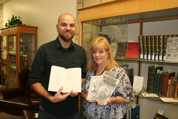MISSOURI STATE UNIVERSITY-West Plains Associate Professor of English Anthony Priest recently donated 20 poetry books, autographed by their authors, from his personal collection to the Garnett Library. He hopes the collection, which includes works by Pulitzer Prize-winning authors, National Book Award for Poetry winners and a former poet laureate, inspiries student writers and gives them insight into the types of writing faculty enjoy. Priest holds a copy of Sonata Mulattica: A Life in Five Movements and a Short Play by Pulitzer Prize-winning poet and former United States Poet Laureate Rita Dove, and Garnett Library Director of Library Services Sylvia Kuhlmeier holds copies of The Secret Names by the late Michael Burns, former Missouri State University professor and director of the creative writing program in Springfield and Under the Sycamore by Missouri State-West Plains per course faculty member Dave Malone. The books are on display in the special/rare books collection, and additional copies of several of the books are available for circulation. (Missouri State-West Plains Photo)