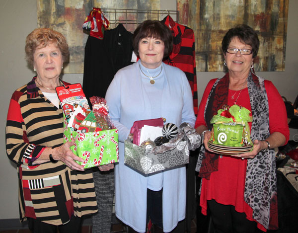 FOUR WEST PLAINS RESIDENTS won giveaways at the “Razzle Dazzle” fashion show Friday, Nov. 4, at the West Plains Country Club. Beverly Linson received a childen’s Christmas variety pack from Cleea’s At Home Market, Vicky Combs won a Brighton Christmas ornament from The Kloz Klozet, and Pam Smith received a beer bread mix and Christmas plates from Cleea’s At Home Market. Dottie Summers was the grand prize giveaway winner and received a Brighton notepad and coin purse and a Crabtree & Evelyn travel pack from The Kloz Klozet and a $25 gift certificate from Cleea’s At Home Market. The annual event, hosted by The Kloz Klozet and Cleea’s At Home Market and sponsored by Friends of the Garnett Library, raises funds to support library needs. From left are Linson, Summers and Smith. (Missouri State-West Plains Photo)