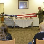 MISSOURI STATE UNIVERSITY-West Plains students William Hatcher, left, West Plains, and Greg Phipps, Willow Springs, both of whom are veterans of the armed services, demonstrate how to properly fold the United States flag as part of a community service project for Connie Yates’ College Reading and Study Skills (IDS 150) class on Veterans Day Nov. 11. The veterans conducted the demonstration to members of Sylvia Hershenson’s third grade class at West Plains Elementary School during a visit to the Garnett Library. Hatcher and Phipps discussed the importance of Veterans Day and answered questions from the students. Following the demonstration, the students attended the annual Veterans Day Parade. Hatcher was a Sergeant E5 in Alpha Troop of the 710th Cavalry in the U.S. Army 4th Infantry Division’s 1st Brigade at Fort Hood, Texas, at the time of his discharge. Phipps was a Corporal in the 2nd Battalion, 9th Marines, 2nd Marine Division at Camp Lejune in Jacksonville, N.C., at the time of his discharge. (Missouri State-West Plains Photo)