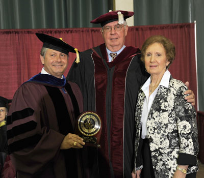 LONGTIME UNIVERSITY SUPPORTERS Jerry and Sue Hall, West Plains, received the prestigious Granvil Vaughan Founder’s Award during Saturday’s Missouri State-West Plains commencement ceremonies at the West Plains Civic Center. Above, the Halls receive the award from Missouri State-West Plains Chancellor Drew Bennett, left. (Missouri State-West Plains Photo)