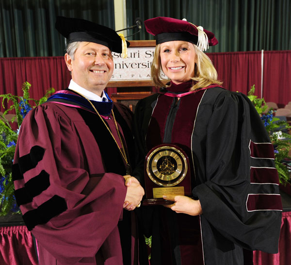 FORMER MISSOURI STATE UNIVERSITY Board of Governors member Mary Sheid received the prestigious Granvil Vaughan Founder’s Award during Saturday’s Missouri State-West Plains commencement ceremonies at the West Plains Civic Center. Above, Sheid receives the award from Missouri State-West Plains Chancellor Drew Bennett. (Missouri State-West Plains Photo)