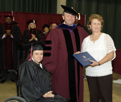 COUCH RESIDENT EDITH WILLIAMS, right, received an honorary Associate of Arts degree Saturday, May 18, during Missouri State University-West Plains’ commencement ceremony at the West Plains Civic Center arena. She received her degree from Missouri State-West Plains Chancellor Drew Bennett. With Williams and Bennett is Williams’ daughter, Jennifer, who graduated with a Bachelor of Science in General Business degree from Missouri State University. (Missouri State-West Plains)