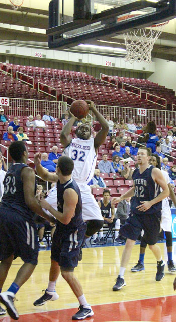 GRIZZLY GUARD JONATHAN TSHIBUY (No. 32) goes up for a bucket during first-half action against Otero Junior College Friday evening at the Grizzly Tip-Off Classic in the Joe Paul Evans Arena at the West Plains Civic Center. The Grizzlies beat Otero 94-93, with Tshibuy scoring 16 of those points. (Photo by Jamie Denbow)