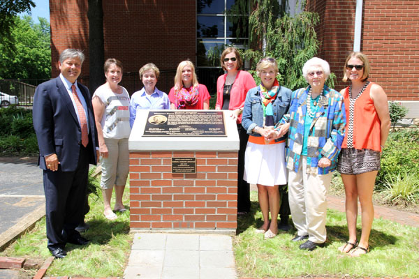 A PLAQUE HONORING FORMER MISSOURI State Rep. Granvil Vaughan and other key community members for founding Missouri State University-West Plains was unveiled Friday, June 13, as part of a newly constructed monument in front of Kellett Hall. The plaque originally was unveiled in 2008 and remained at Kellett Hall until officials found an appropriate, prominent location on campus for it’s display. That location was made possible with donations to the university from family and friends in memory of longtime local businessman Sam Grisham following his death in 2012. Family members requested the funds be used for “something special” at Kellett Hall, which was once home to Grisham’s grandparents. In addition to the founders plaque, the monument includes a plaque honoring Grisham which reads “In memory of Samuel Howard Grisham in recognition of happy childhood memories spent at the home of his grandparents, Ruth and Howard Kellett.” On hand for the unveiling were, from left, Missouri State-West Plains Chancellor Drew Bennett; Vaughan’s daughters Reta Tyrrell, Mountain Grove, and Karyn Vaughan, West Plains; Grisham’s daughters Mary-Louise Tollenaar, West Plains, and Catherine White, Jefferson City; Grisham’s wife and mother, Elizabeth Grisham and Jeanette Grisham, both of West Plains; and Grisham’s daughter Margaret Schloss, Fayetteville, Ark. (Missouri State-West Plains Photo)