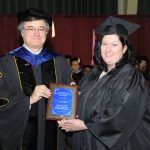 LACY MILL, West Plains, received the Outstanding Student Award for Associate of Arts/Associate of Applied Science degree graduates at Missouri State University-West Plains’ commencement ceremonies Saturday, May 18, at the West Plains Civic Center. The award recognizes a graduate from either the AA or AAS programs who exhibits academic excellence, interest and enthusiasm in learning, conscientiousness, academic honesty, a willingness to participate and help others in class, and exceptional university and community service. Mill graduated with an Associate of Arts in General Studies, Associate of Applied Science in Child and Family Development and Bachelor of Science in Child and Family Development degrees during Saturday’s commencement. She received her award from Dean of Academic Affairs Dr. Christopher Dyer. (Missouri State-West Plains Photo)