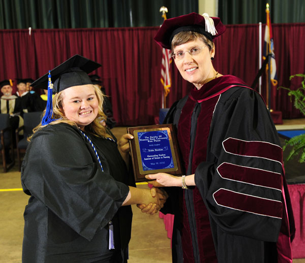 TRISHA HAWKINS, left, Gainesville, received the Outstanding Student Award for Associate of Science in Nursing degree graduates at Missouri State University-West Plains’ commencement ceremonies Saturday, May 19, at the West Plains Civic Center. The award recognizes a graduate from ASN program who exhibits academic achievement and honesty, class participation, conscientiousness, university and community service, and outstanding clinical performance. She received her award from Missouri State University Board of Governors member Elizabeth Bradbury, Center, Mo. (Missouri State-West Plains Photo)