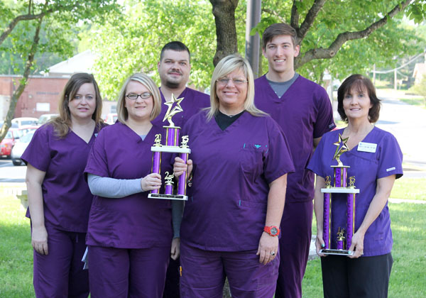 SECOND-YEAR STUDENTS in the Associate of Applied Science in Respiratory Care program at Missouri State University-West Plains placed second out of 15 teams in the student division of the Sputum Bowl at the 44th annual conference and business meeting of the Missouri Society for Respiratory Care April 21-24 at Tan-Tar-A Resort and Conference Center at Osage Beach. Cindy Smith, director of the program, was on a team of respiratory care educators and practitioners that took first place in the professional division of the contest. The contest is designed to stimulate interest in current knowledge and practices of respiratory care, Smith said, adding her team will represent Missouri at the national professional Sputum Bowl competition during the American Association for Respiratory Care’s annual conference in November in Tampa, Fla. The student team defeated a team from the University of Missouri-Columbia in the semifinal round before losing to a team from Missouri Southern State University in Joplin in the finals. With their trophies are, from left, Coordinator of Clinical Education for Respiratory Care Aimee Green; students Whitney Slaughter, Thayer, Perry Elliott, West Plains, Tiffany Green, St. Louis, and Mathew Neil, Winona; and Smith. (Missouri State-West Plains Photo)
