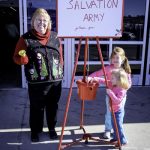 Assistant Professor of Accounting/Entrepreneurship Barbara Nyden welcomes sisters Addison and Caroline Smith, ages four and two, of West Plains as they drop off their donation for the Salvation Army's Red Kettle campaign in front of Walmart Supercenter in West Plains. The children are the daughters of Amanda Smith. (Missouri State-West Plains Photo)