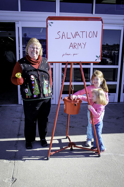 Assistant Professor of Accounting/Entrepreneurship Barbara Nyden welcomes sisters Addison and Caroline Smith, ages four and two, of West Plains as they drop off their donation for the Salvation Army's Red Kettle campaign in front of Walmart Supercenter in West Plains. The children are the daughters of Amanda Smith. (Missouri State-West Plains Photo)