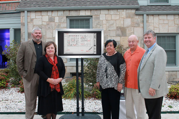 OFFICIALS AT MISSOURI STATE University-West Plains hosted a surprise reception Thursday evening to announce the Carol Silvey Student Union will be housed in the post office building on Garfield Avenue once its renovation and expansion is complete. Members of the university’s development board, donors and some of Silvey’s close friends attended the event at the Richards House. With a sketch of the post office’s planned interior renovations are, from left, Silvey’s son-in-law and daughter, John and Christena Silvey Coleman, Silvey and her husband, Richard, and Missouri State-West Plains Chancellor Drew Bennett. (Missouri State-West Plains Photo)