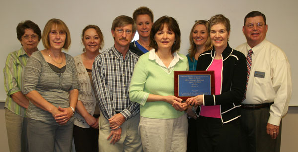 THE STAFF of Missouri State University-West Plains’ Department of Student Services won the “Highest Dollar Amount Raised” Award in the departmental contest at the university’s 18th annual auction April 13. This is the third consecutive year the department has won the award. On hand for the plaque presentation were, front row from left, Food Services Manager Mozella Jett, Student Life & Development Coordinator Rogers Taylor, Drago College Store Manager Kathy Schloss, and Director of Development Elizabeth Grisham. Back row: Coordinator of Financial Aid Donna Bassham, Coordinator of Admissions Melissa Jett, Grizzly Volleyball Head Coach Paula Wiedemann, Registrar Shanna Dale and Dean of Student Services Dr. Herb Lunday. (Missouri State-West Plains Photo)