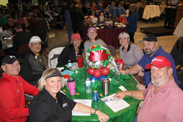 “TEE IT UP” was the theme of this table which placed second in the table-decorating contest of the 14th annual Trivia Night benefitting Grizzly Athletics at Missouri State University-West Plains Jan. 28 at the West Plains Civic Center. Team members included, from left, Kristi Landsdown, Doug Landsdown, Dan Petrus, Amy Petrus, Tracy Finley, Melissa Robbins, Jason Robbins and Gary Johnson. (Missouri State-West Plains Photo)