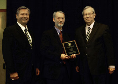 DR. GARY L. PHILLIPS, center, associate professor of communication at Missouri State University-West Plains, received the Governor’s Award for Excellence in Education during an April 3 luncheon in Columbia, Mo. With him are Missouri State-West Plains Chancellor Drew Bennett, left, and Missouri Commissioner of Higher Education David R. Russell. (Photo provided)