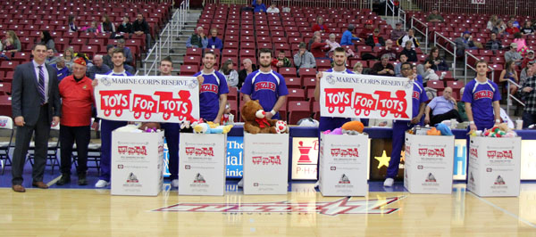 A TOTAL OF 515 new or gently used soft stuffed toys were collected for the U.S Marine Corps Reserve’s annual Toys for Tots campaign during Saturday’s toy toss at the Missouri State University-West Plains Grizzly Basketball game against Iowa Western Community College in the West Plains Civic Center arena. Fans who brought a toy to the game received free admission. Toys were then tossed onto the court after the Grizzlies scored their first points of the contest and given to Toys for Tots for distribution to children in the area who are less fortunate, organizers said. Student organizations were challenged by Missouri State-West Plains Chancellor Drew Bennett to have their members attend the game and bring toys for a $100 prize. The Ag Club won the challenge with 34 members in attendance and 134 stuffed toys collected and donated. With the toys are, from left, Grizzly Basketball Head Coach Chris Popp, U.S. Marine Corps Reserve Jack McNevin, and Grizzly Cheerleaders Peytan Bassett, Michael Mayo, Reece Totty, Skyler Tompkins, Colt Tompkins, Chris Rodgers-Smith and Seth Evans. (Missouri State-West Plains Photo)