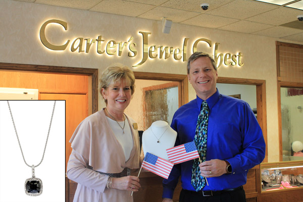 THIS 3 CARAT BLACK DIAMOND pendant donated by Carter’s Jewel Chest in Mountain Home, Ark., is one of many items up for bid at the April 7 “Red, White and True Blue” annual auction hosted by Missouri State-West Plains. With the necklace above are Beth Carter of Carter’s Jewel Chest and Missouri State-West Plains Director of Development Joe Kammerer. (Photo provided)